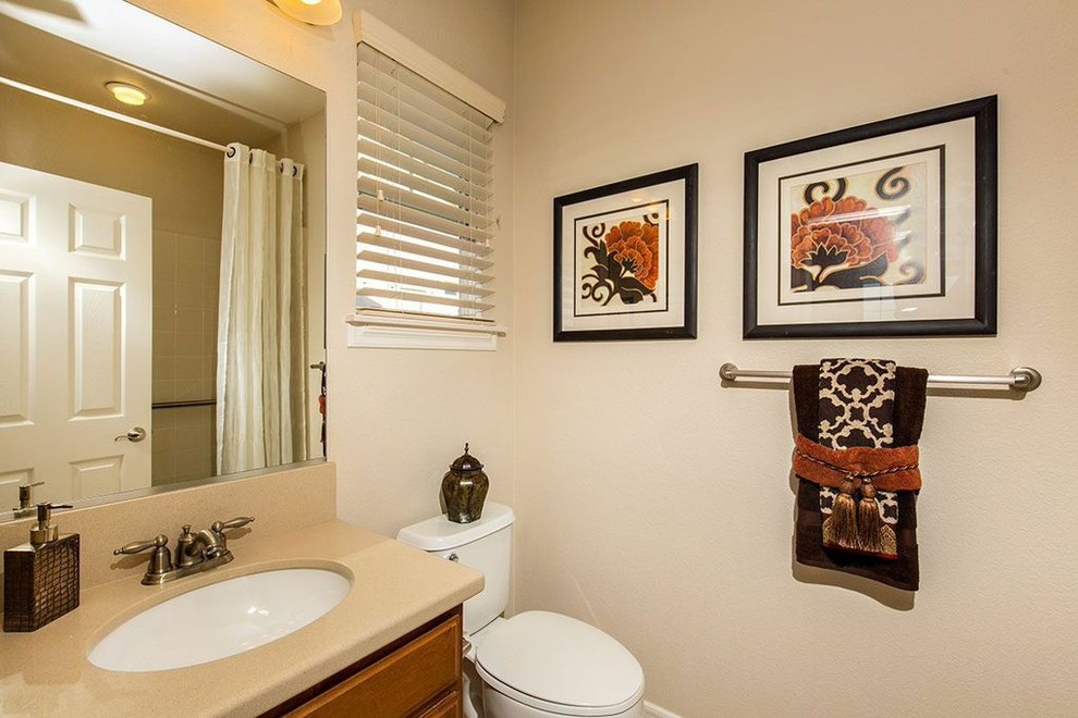 Imagen de cuarto de baño tradicional renovado con armarios con paneles con relieve, puertas de armario de madera oscura, encimera de cuarcita y suelo de travertino