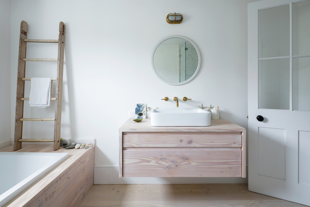 Inspiration for a scandinavian bathroom in London with a vessel sink.