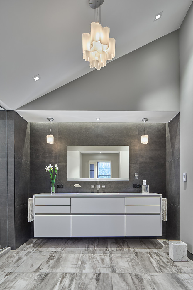 На фото: главная ванная комната в современном стиле с плоскими фасадами, белыми фасадами, серой плиткой, серыми стенами и серым полом с