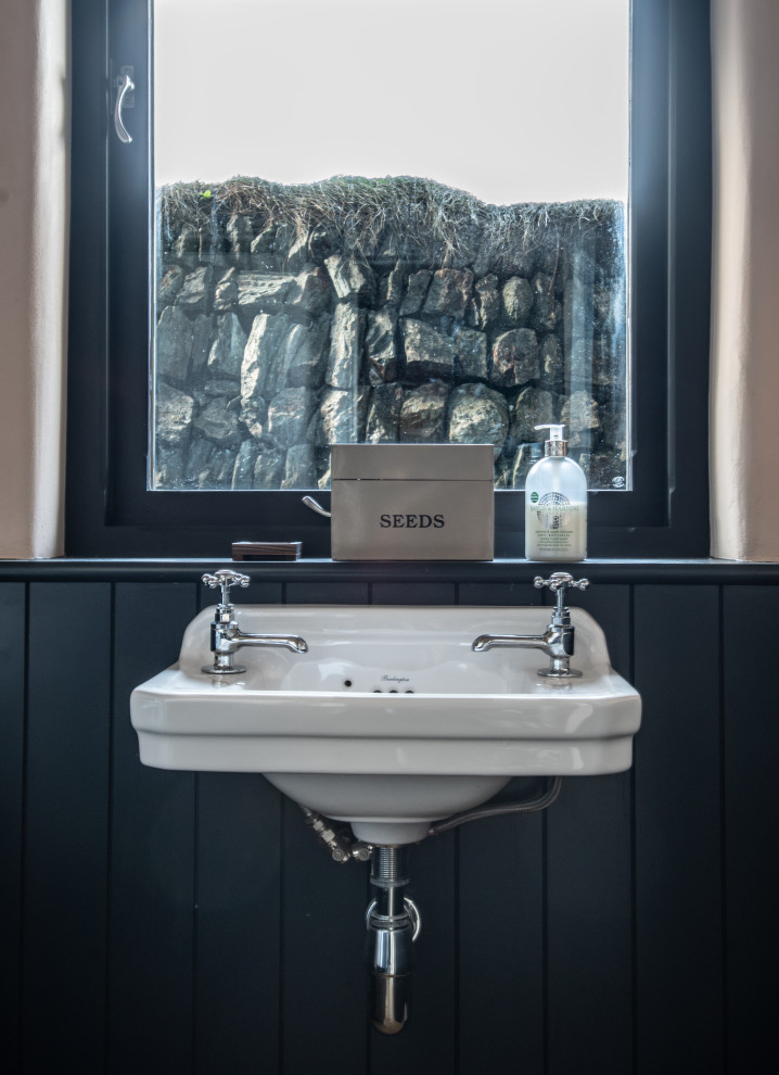 Inspiration for a medium sized coastal family bathroom in Cornwall with a two-piece toilet, beige walls, cement flooring, a wall-mounted sink and grey floors.
