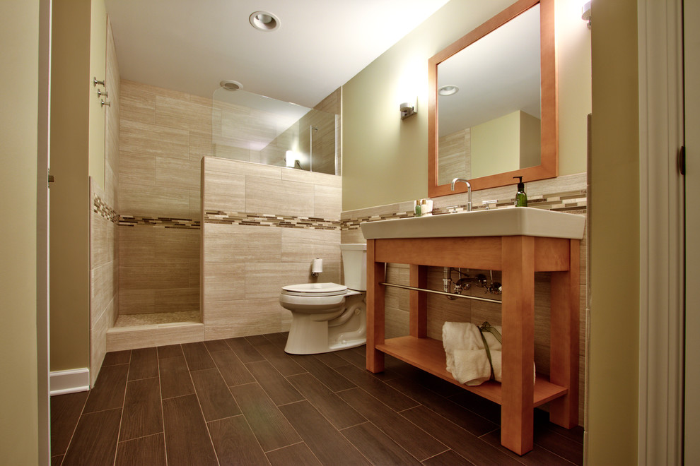Design ideas for a large contemporary ensuite half tiled bathroom in Chicago with open cabinets, light wood cabinets, an alcove shower, beige tiles, brown tiles, white tiles, a two-piece toilet, beige walls and a console sink.