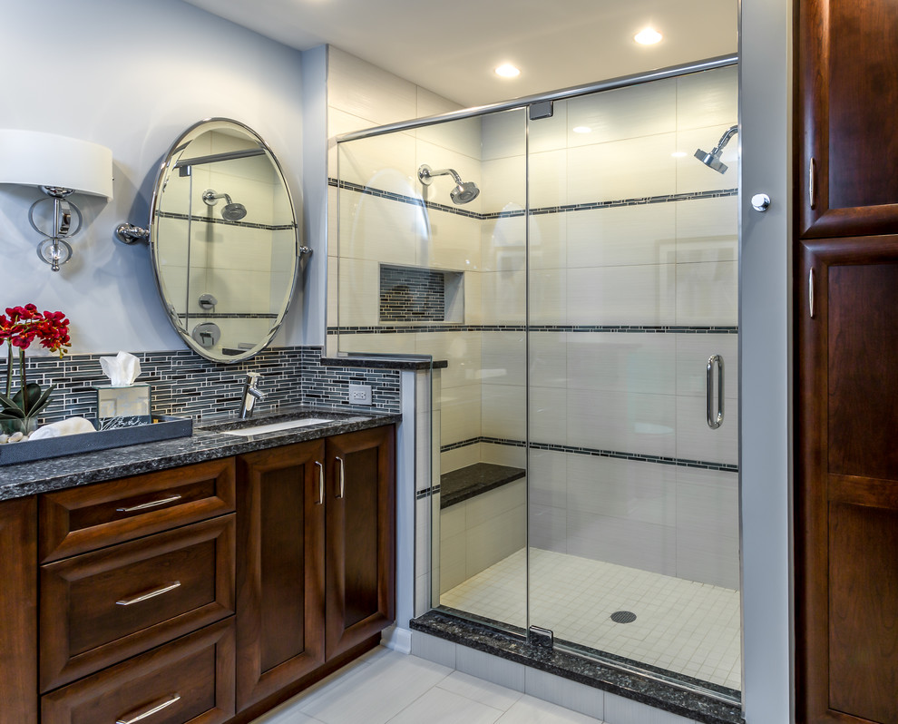Double shower - mid-sized contemporary master gray tile and glass tile porcelain tile double shower idea in Chicago with an undermount sink, recessed-panel cabinets, medium tone wood cabinets, granite countertops, a two-piece toilet and gray walls