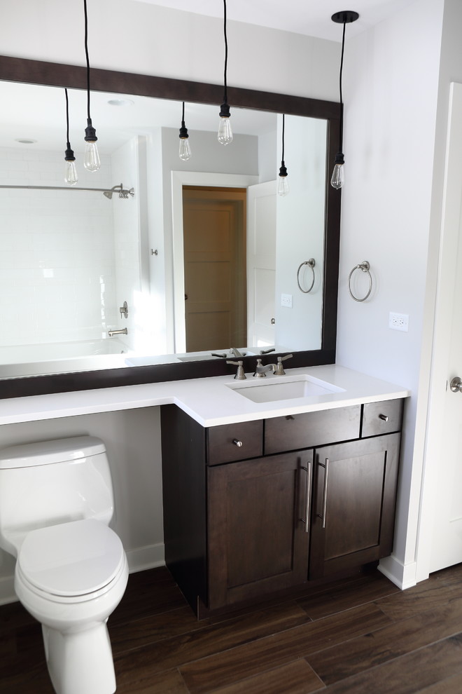 This is an example of a medium sized midcentury ensuite bathroom in Tampa with a submerged sink, flat-panel cabinets, dark wood cabinets, engineered stone worktops, a corner shower, brown tiles, ceramic tiles, grey walls and ceramic flooring.