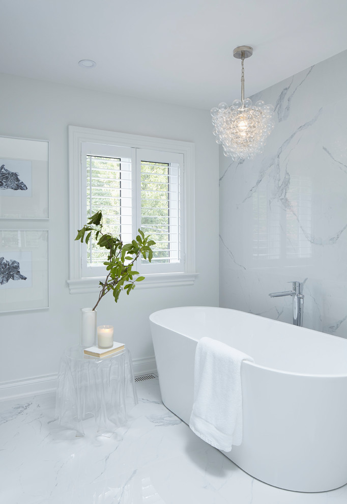 Inspiration for a medium sized contemporary ensuite bathroom in Toronto with flat-panel cabinets, white cabinets, a freestanding bath, a corner shower, a one-piece toilet, white tiles, porcelain tiles, white walls, porcelain flooring, a submerged sink, quartz worktops, white floors and a hinged door.
