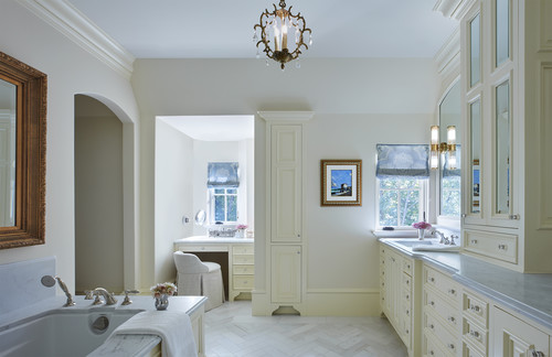 white cabinets and vanity nook in elegant french inspired bathroom