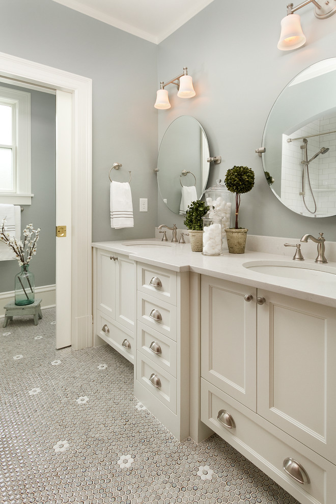 Diseño de cuarto de baño infantil tradicional renovado con lavabo encastrado, armarios estilo shaker, puertas de armario blancas, encimera de cuarzo compacto, baldosas y/o azulejos grises, paredes grises y suelo con mosaicos de baldosas