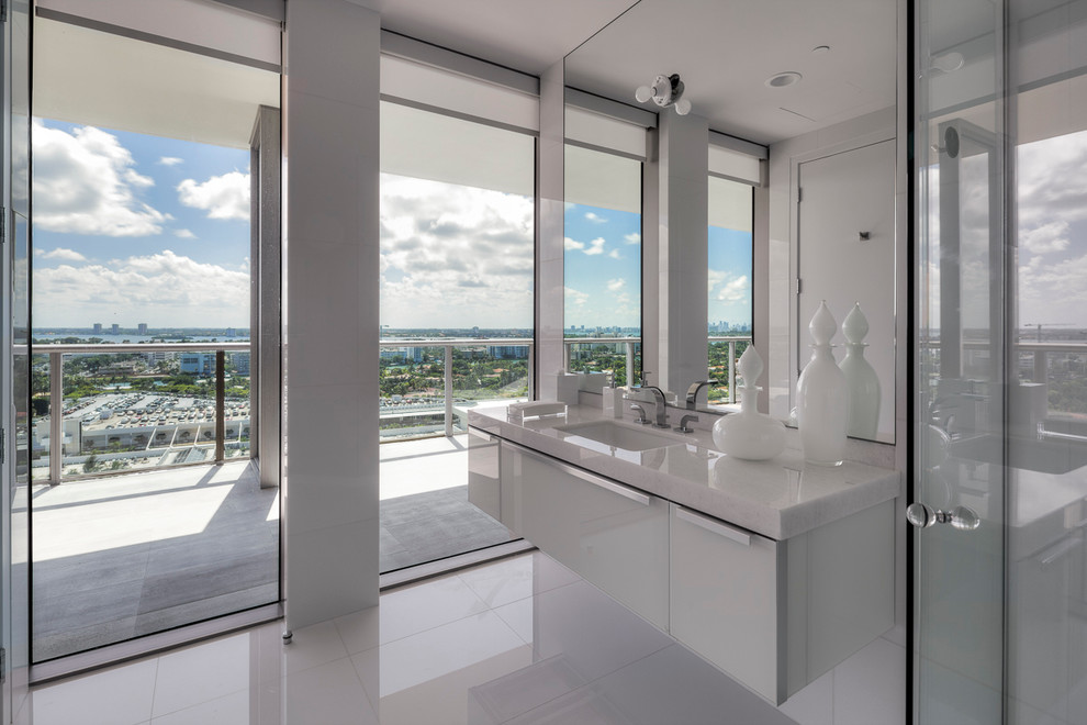 Design ideas for a contemporary bathroom in Miami with a submerged sink, quartz worktops, a walk-in shower, a one-piece toilet, white tiles, porcelain tiles, white walls and marble flooring.