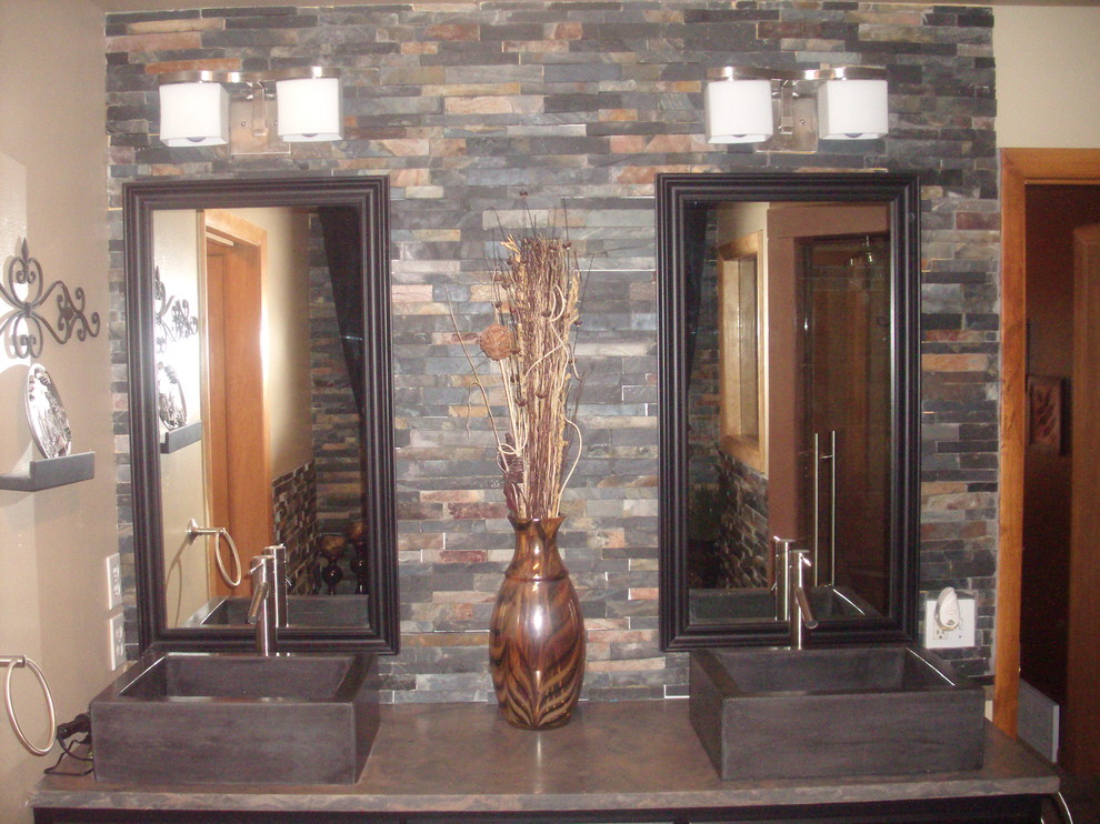 Stacked slate bathroom, with concrete countertops, vessel sinks, shower
