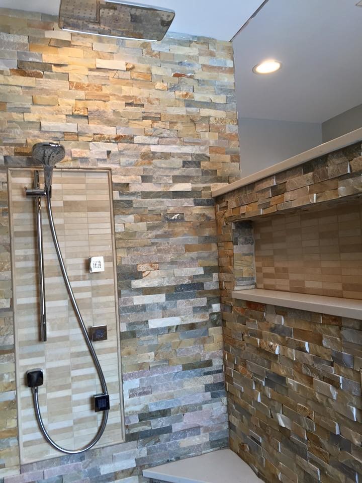 Inspiration for a large contemporary ensuite bathroom in Detroit with shaker cabinets, dark wood cabinets, a walk-in shower, a one-piece toilet, brown tiles, stone tiles, brown walls, medium hardwood flooring and a submerged sink.