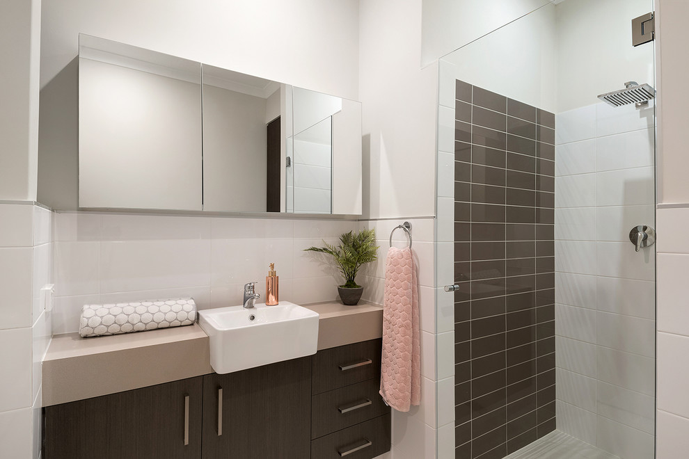 Inspiration for a contemporary bathroom in Perth with flat-panel cabinets, dark wood cabinets, a corner shower, brown tiles, white tiles, metro tiles, white walls, a built-in sink, a hinged door and beige worktops.