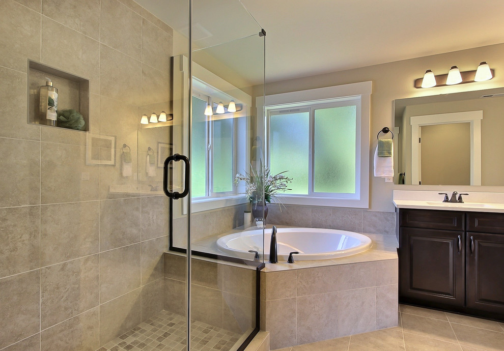 Bathroom - mid-sized transitional master porcelain tile porcelain tile bathroom idea in Seattle with raised-panel cabinets, dark wood cabinets, quartzite countertops and beige walls