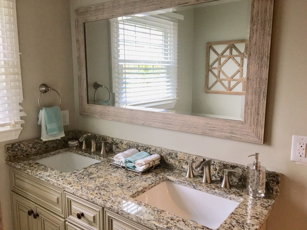 Inspiration for a small country master bathroom remodel in Other with raised-panel cabinets, beige cabinets, beige walls, an undermount sink, granite countertops and multicolored countertops
