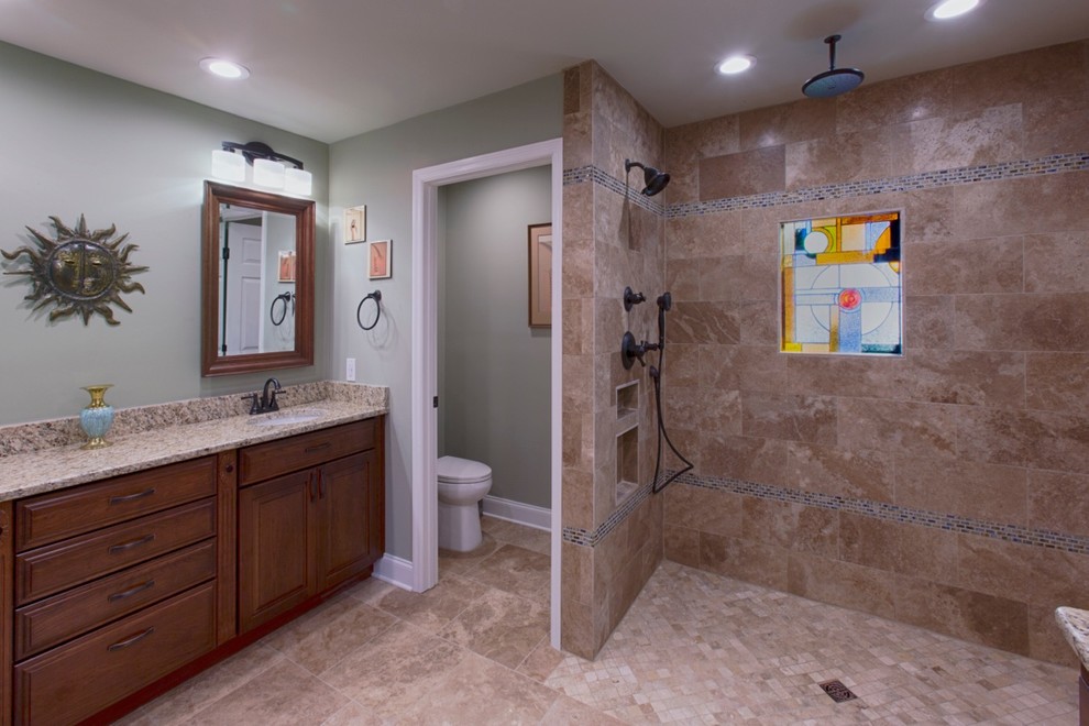 Inspiration for a traditional bathroom in Nashville with a submerged sink, recessed-panel cabinets, dark wood cabinets, granite worktops, a built-in shower, a two-piece toilet, beige tiles and stone tiles.