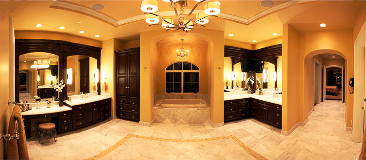 Example of a large tuscan master white tile bathroom design in Phoenix with raised-panel cabinets, dark wood cabinets and quartzite countertops