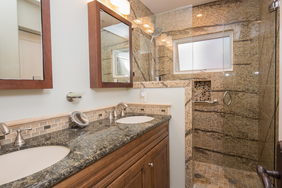Inspiration for a small transitional beige tile and stone tile walk-in shower remodel in San Diego with an undermount sink, raised-panel cabinets, medium tone wood cabinets, granite countertops and white walls