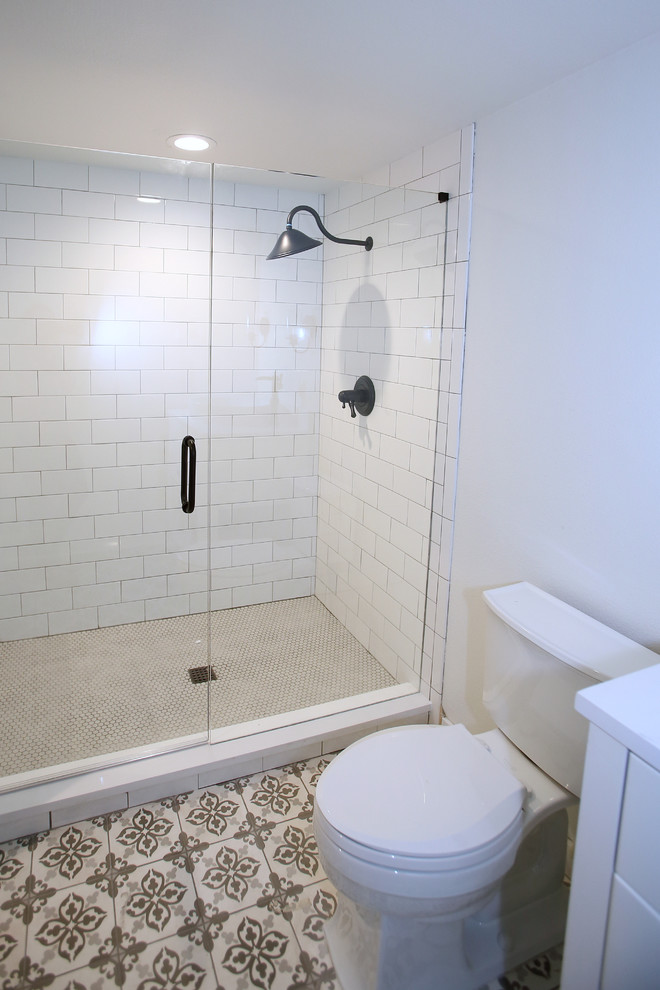 Inspiration for a mid-sized transitional 3/4 gray tile and subway tile porcelain tile and gray floor doorless shower remodel in Dallas with flat-panel cabinets, white cabinets, a one-piece toilet, gray walls, a pedestal sink, quartz countertops and a hinged shower door