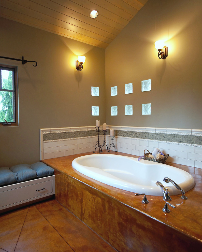 This is an example of a bohemian bathroom in Seattle with metro tiles, a built-in bath and concrete flooring.
