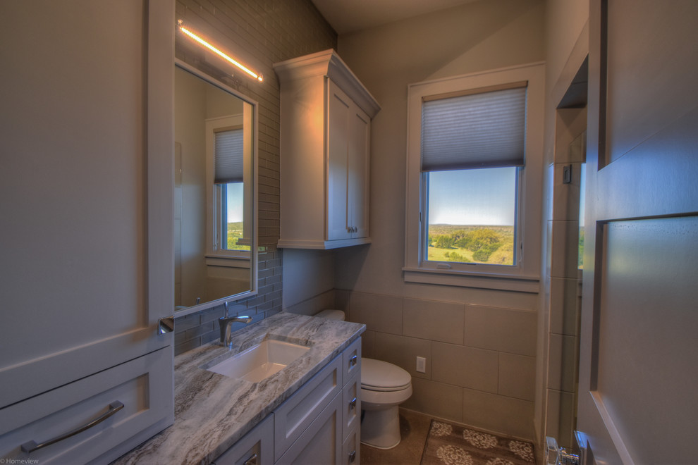 This is an example of a medium sized contemporary family bathroom in Austin with shaker cabinets, grey cabinets, grey tiles, grey walls, concrete flooring, a submerged sink and granite worktops.