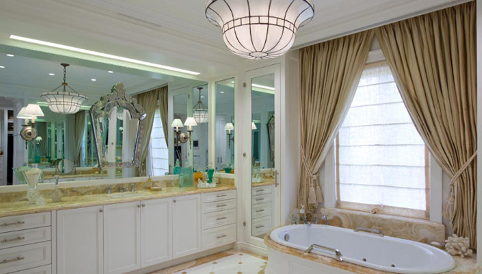 Example of a large classic bathroom design in Miami with white cabinets, white walls, an undermount sink and marble countertops