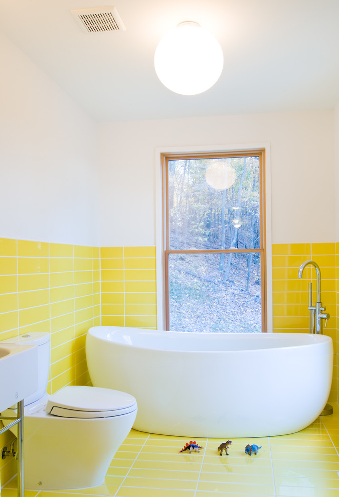 This is an example of a small contemporary family bathroom in DC Metro with an integrated sink, a freestanding bath, a two-piece toilet, yellow tiles, porcelain tiles, white walls, porcelain flooring and yellow floors.