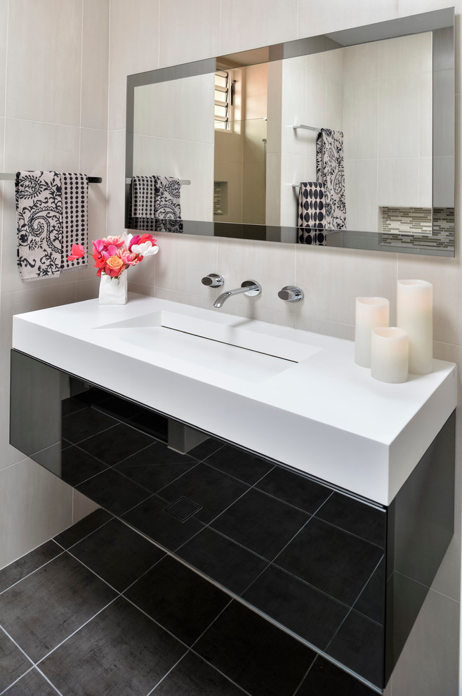 Example of a mid-sized trendy master brown tile and ceramic tile ceramic tile bathroom design in Sydney with an integrated sink, black cabinets, a one-piece toilet, beige walls and flat-panel cabinets