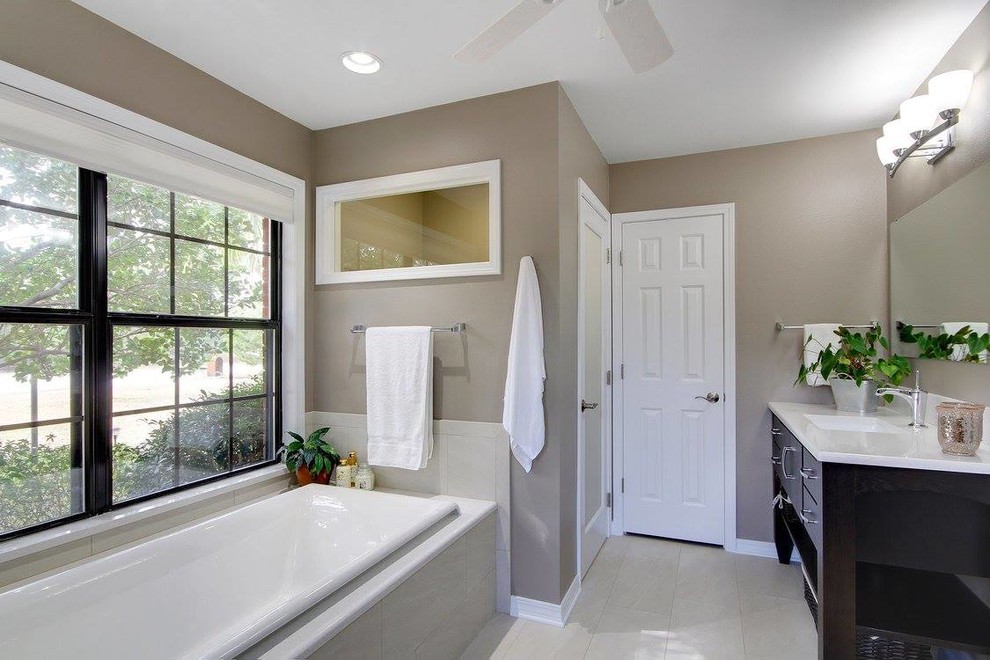 Large transitional master beige tile and porcelain tile porcelain tile and beige floor bathroom photo in Bridgeport with flat-panel cabinets, dark wood cabinets, a two-piece toilet, beige walls, an undermount sink, solid surface countertops and a hinged shower door