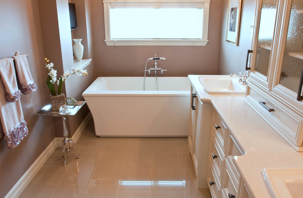 Пример оригинального дизайна: ванная комната среднего размера в классическом стиле с фасадами с утопленной филенкой, белыми фасадами, отдельно стоящей ванной, бежевыми стенами, полом из керамической плитки, накладной раковиной и душем в нише