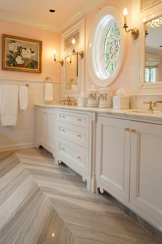 Mid-sized elegant master white tile, beige tile and stone tile marble floor bathroom photo in Other with a two-piece toilet, an undermount sink, beaded inset cabinets, white cabinets, pink walls and marble countertops