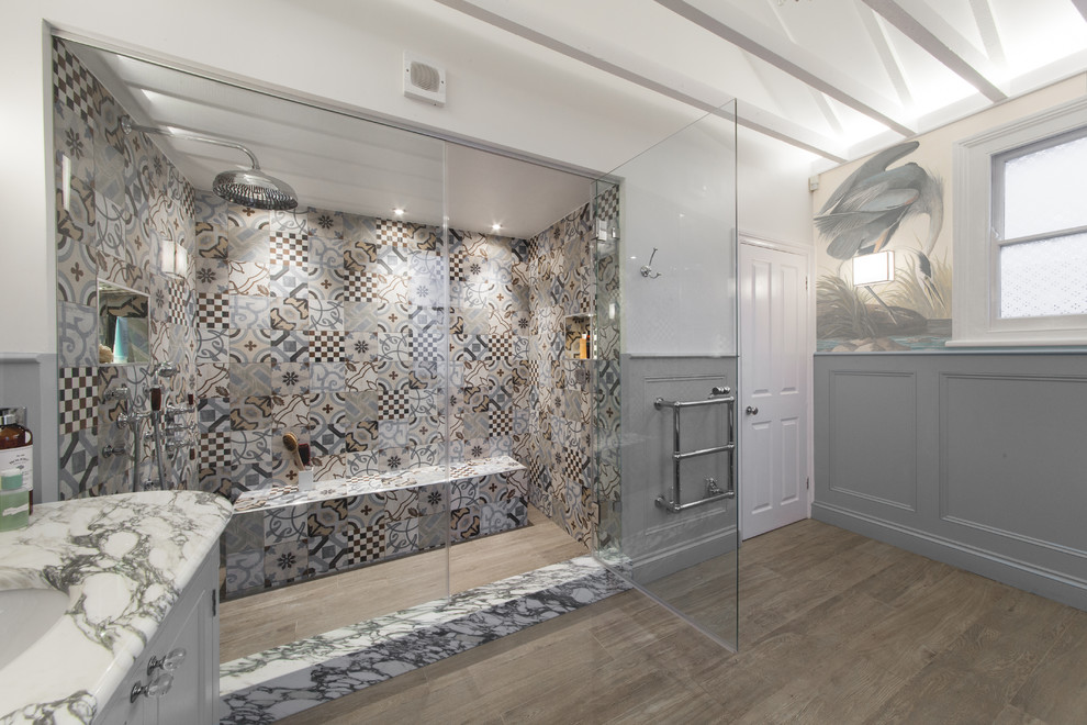 Large eclectic kids' multicolored tile and porcelain tile porcelain tile bathroom photo in London with recessed-panel cabinets, gray cabinets, a two-piece toilet, multicolored walls, a drop-in sink and marble countertops