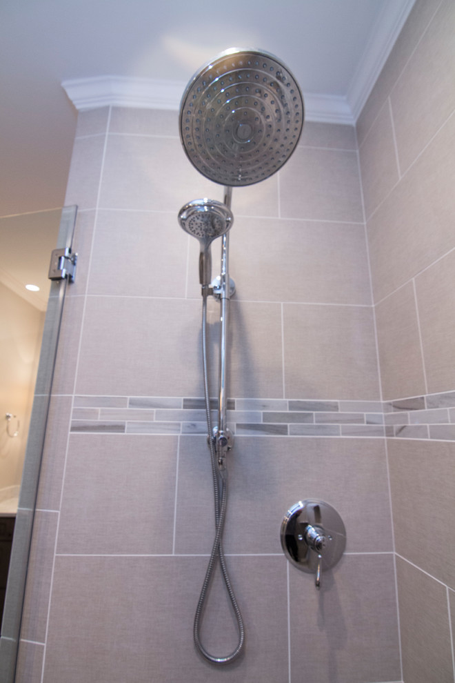 Example of a mid-sized classic master beige tile and porcelain tile porcelain tile and gray floor corner shower design in Raleigh with flat-panel cabinets, gray cabinets, a two-piece toilet, gray walls, an undermount sink, quartz countertops and a hinged shower door