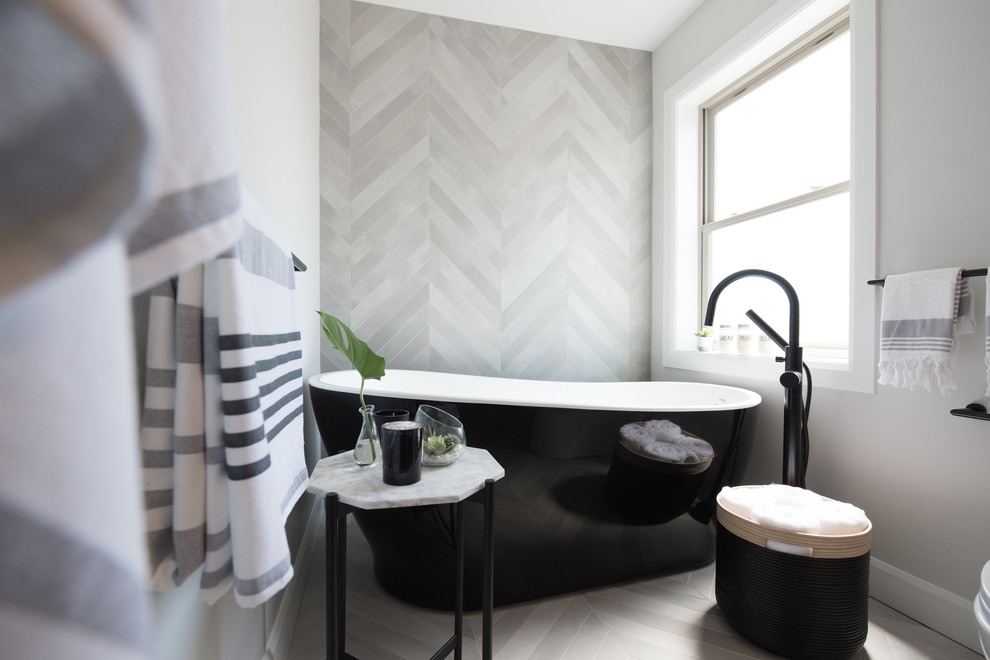 Inspiration for a mid-sized modern master gray tile and porcelain tile porcelain tile and gray floor bathroom remodel in Montreal with flat-panel cabinets, dark wood cabinets, a one-piece toilet, gray walls, an undermount sink, quartzite countertops and white countertops