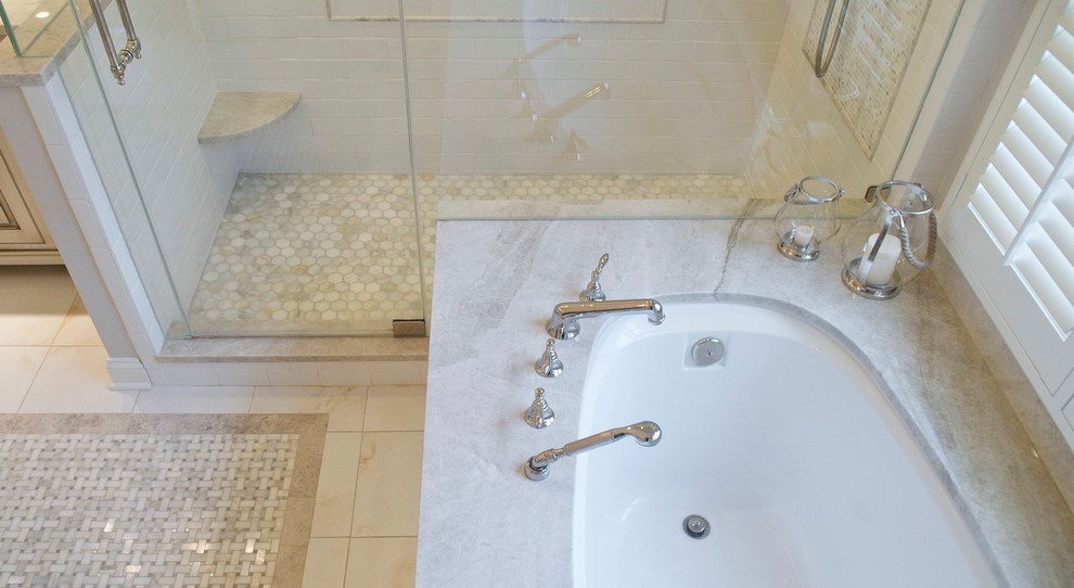 This is an example of a large traditional ensuite bathroom in New York with beaded cabinets, beige cabinets, a submerged bath, a corner shower, a two-piece toilet, white tiles, marble tiles, beige walls, marble flooring, a submerged sink, quartz worktops, beige floors and a hinged door.