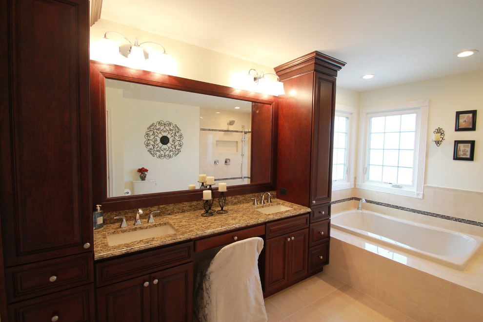 Exemple d'une grande salle de bain principale chic en bois brun avec un lavabo encastré, un placard avec porte à panneau surélevé, un plan de toilette en granite, une baignoire posée, WC séparés, un carrelage beige, des carreaux de céramique, un mur beige et un sol en carrelage de porcelaine.