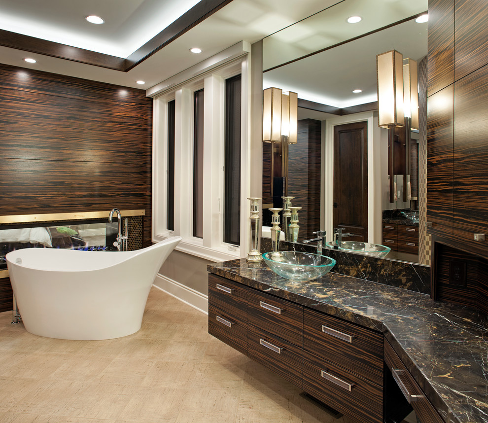 Design ideas for a contemporary ensuite bathroom in Minneapolis with granite worktops, a freestanding bath, ceramic flooring, a vessel sink, flat-panel cabinets and dark wood cabinets.
