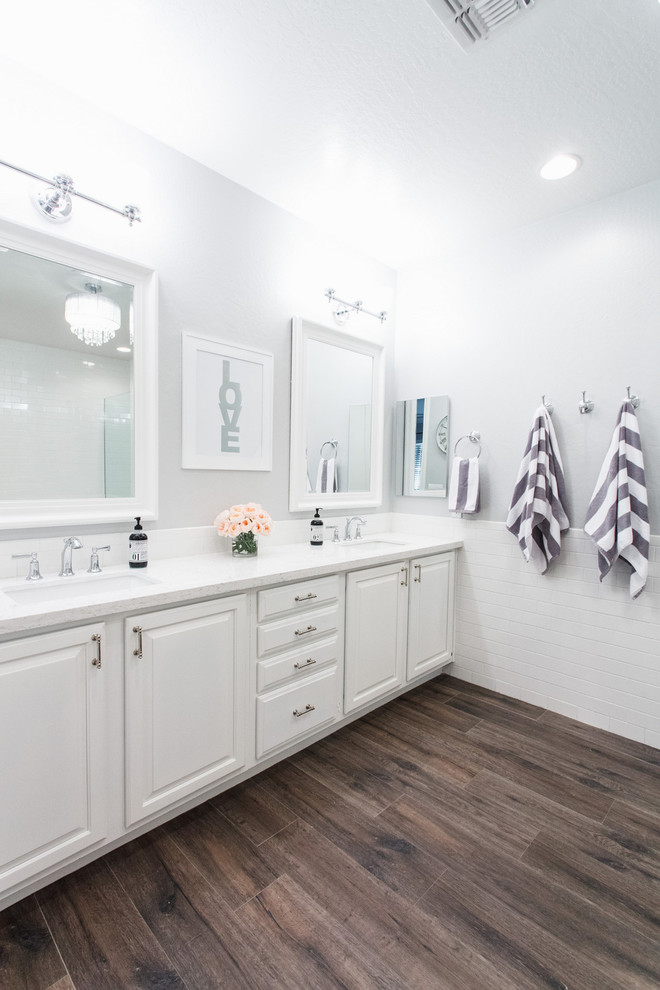 Inspiration for a mid-sized modern master white tile and subway tile ceramic tile corner shower remodel in Phoenix with raised-panel cabinets, white cabinets, a hot tub, a one-piece toilet, gray walls, an undermount sink and quartzite countertops