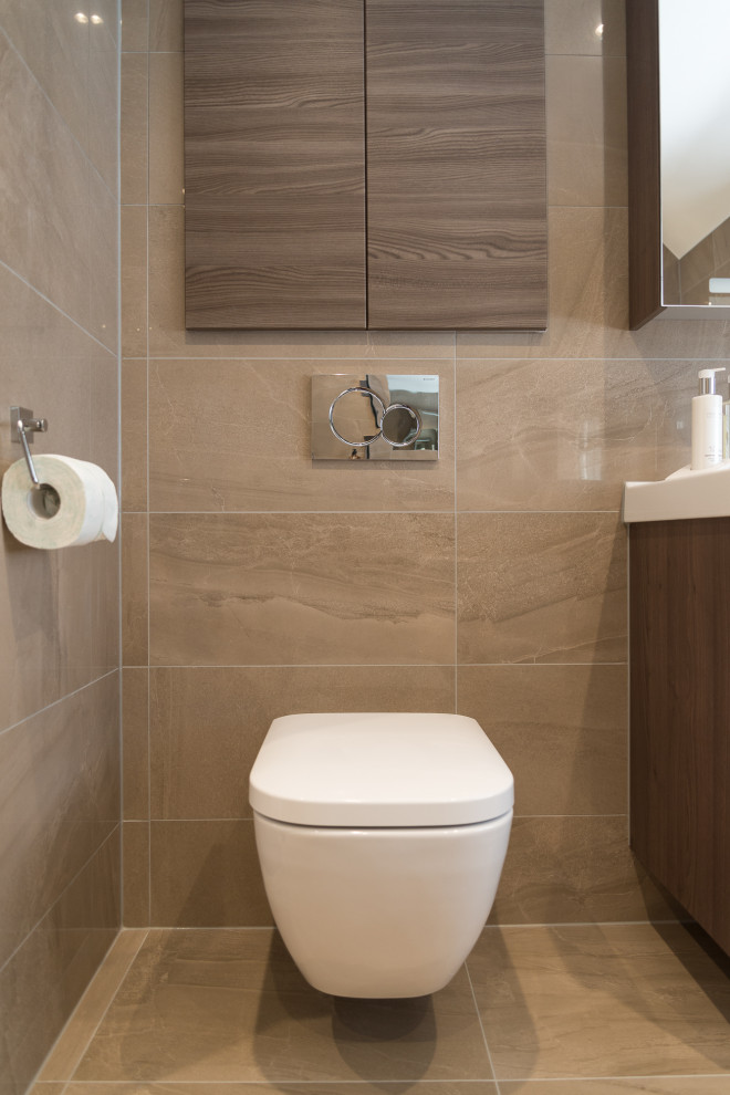 Inspiration for a large modern master brown tile and porcelain tile porcelain tile, brown floor and single-sink bathroom remodel in Berkshire with flat-panel cabinets, dark wood cabinets, a wall-mount toilet, brown walls, an integrated sink and a floating vanity