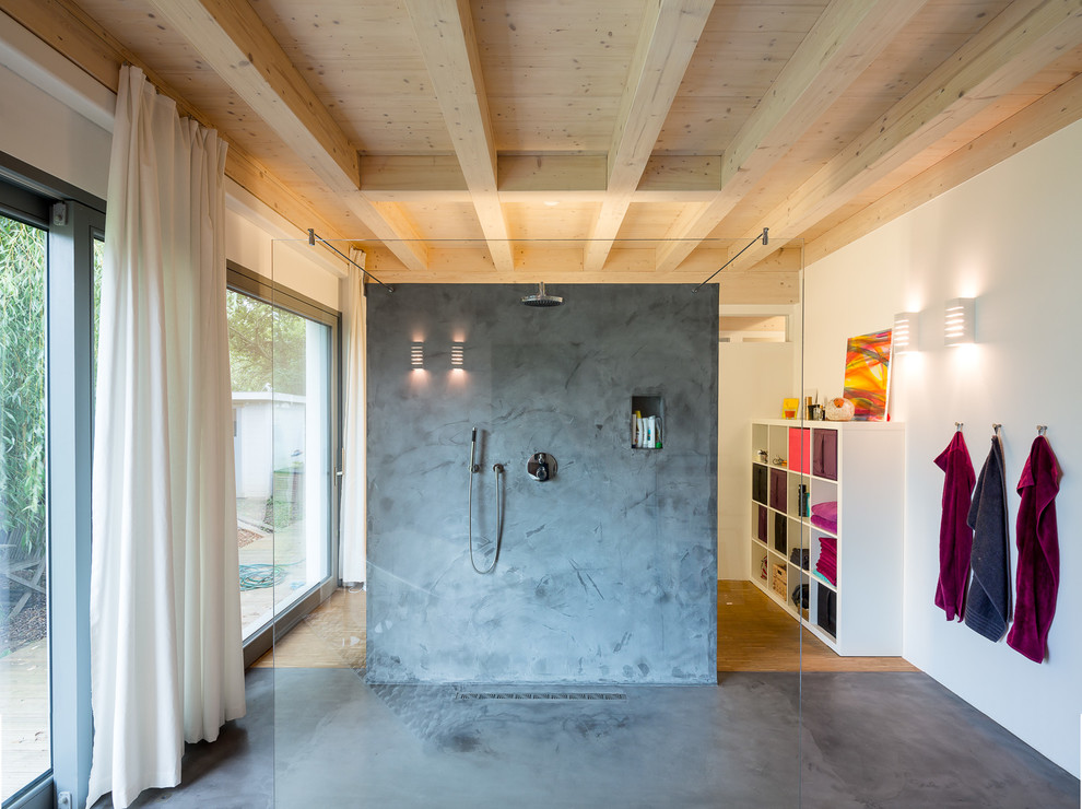 This is an example of a large contemporary bathroom in Cologne with white walls, concrete flooring, open cabinets, a walk-in shower and an open shower.