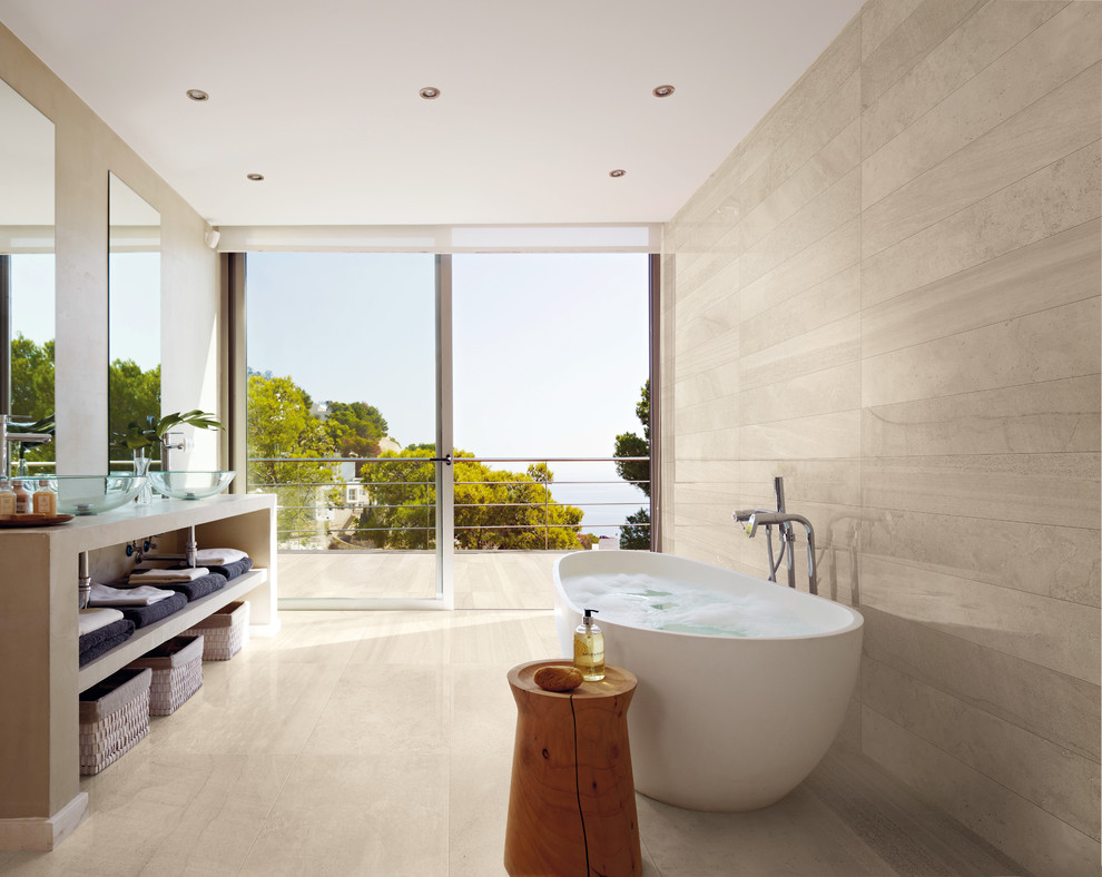 Photo of a large contemporary ensuite bathroom in San Francisco with white tiles, porcelain tiles, porcelain flooring, open cabinets, a freestanding bath, a vessel sink, brown cabinets, beige walls and beige floors.