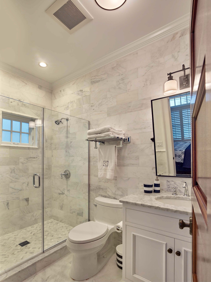 Свежая идея для дизайна: ванная комната среднего размера в морском стиле с фасадами с утопленной филенкой, белыми фасадами, душем в нише, унитазом-моноблоком, серой плиткой, белой плиткой, каменной плиткой, мраморным полом, душевой кабиной, врезной раковиной, мраморной столешницей, белым полом и душем с распашными дверями - отличное фото интерьера