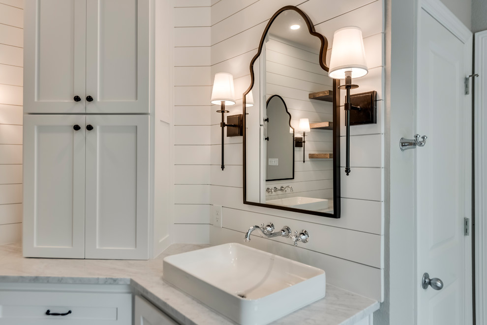 Example of a large cottage master white tile and porcelain tile ceramic tile and gray floor bathroom design in Dallas with shaker cabinets, white cabinets, a two-piece toilet, gray walls, a vessel sink, marble countertops, a hinged shower door and white countertops