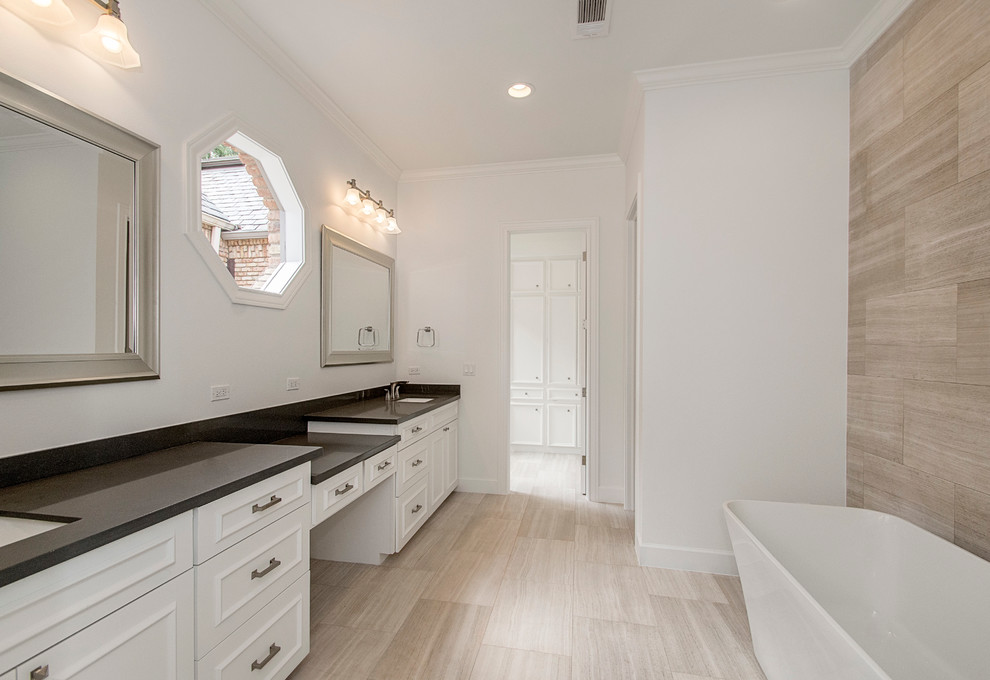 Large traditional ensuite bathroom in Dallas with raised-panel cabinets, white cabinets, a freestanding bath, an alcove shower, a one-piece toilet, brown tiles, ceramic tiles, white walls, porcelain flooring, a submerged sink and quartz worktops.