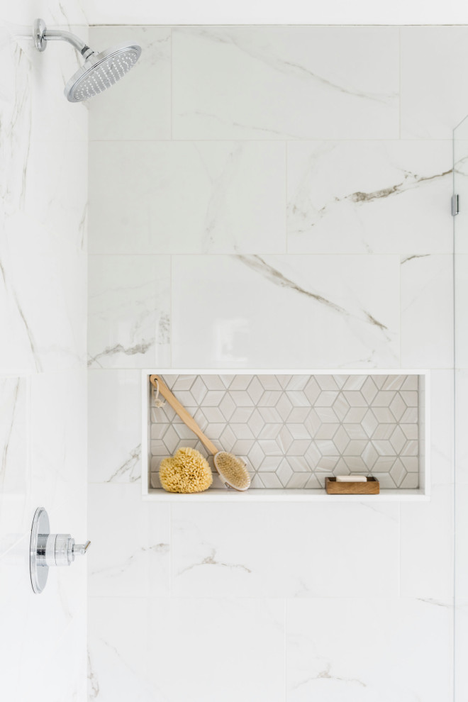 Corner shower - large traditional master white tile and porcelain tile porcelain tile and beige floor corner shower idea in Charlotte with shaker cabinets, gray cabinets, a two-piece toilet, white walls, an undermount sink, marble countertops, a hinged shower door and gray countertops