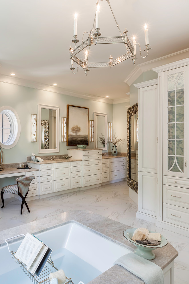 Photo of a traditional bathroom in Other with raised-panel cabinets, white cabinets, a submerged bath, a built-in shower, a submerged sink, white floors, a hinged door, grey worktops, white tiles, porcelain tiles, porcelain flooring and quartz worktops.