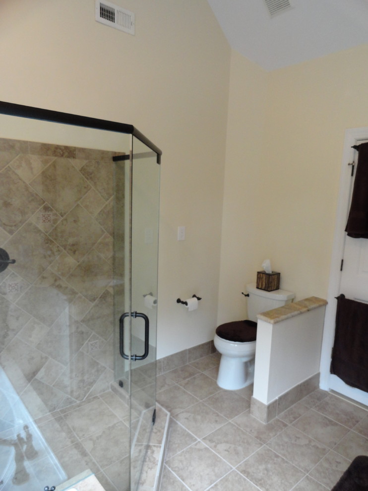 Design ideas for a medium sized traditional ensuite bathroom in Raleigh with a submerged sink, raised-panel cabinets, white cabinets, granite worktops, a built-in bath, a corner shower, a two-piece toilet, beige tiles, porcelain tiles, beige walls and porcelain flooring.