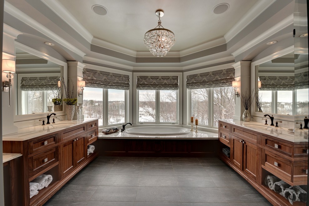 This is an example of a traditional bathroom in Minneapolis with a submerged sink, dark wood cabinets, black tiles and a built-in bath.