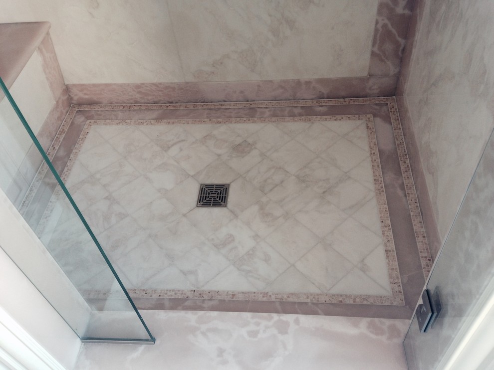 Inspiration for a medium sized traditional ensuite bathroom in New York with marble flooring, an alcove shower, a two-piece toilet, black and white tiles, stone tiles and marble worktops.
