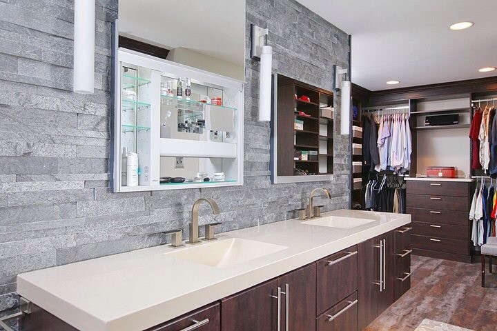 Large trendy master gray tile and porcelain tile linoleum floor alcove shower photo in Philadelphia with an integrated sink, flat-panel cabinets, dark wood cabinets, solid surface countertops, a wall-mount toilet and gray walls