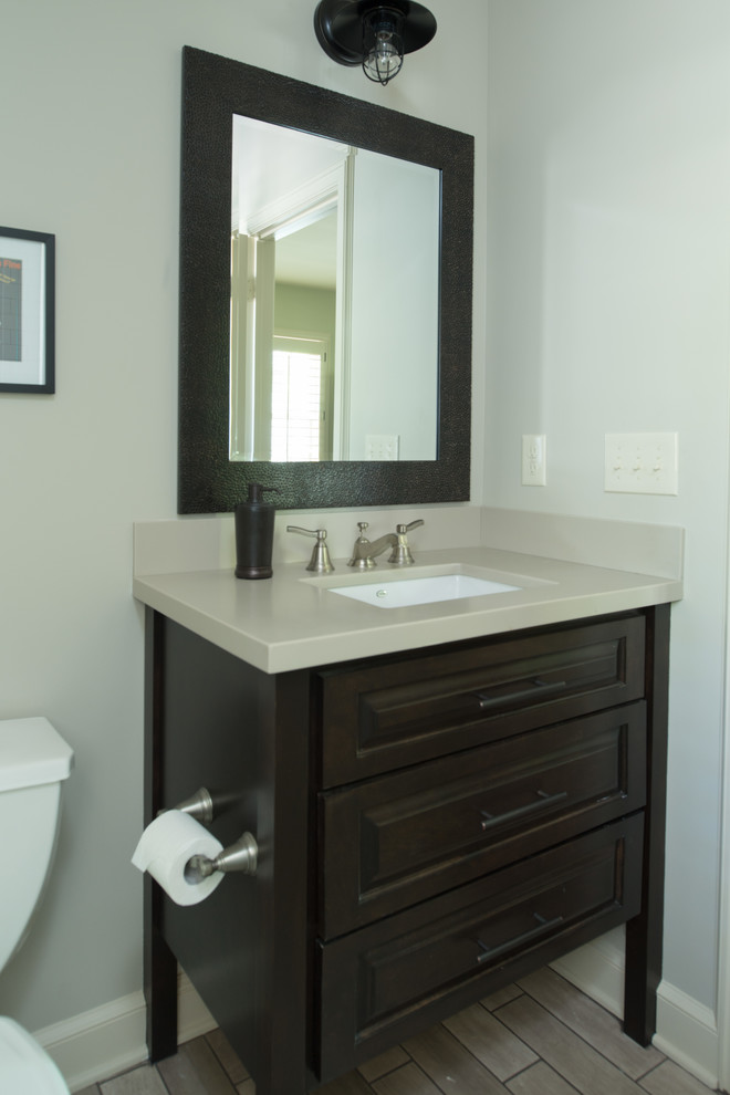 Mid-sized arts and crafts master bathroom photo in Kansas City with raised-panel cabinets, brown cabinets, quartz countertops, beige walls and an undermount sink