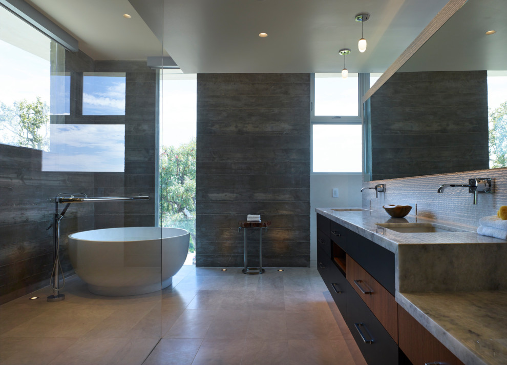 Inspiration for a large contemporary master white tile and porcelain tile porcelain tile and gray floor bathroom remodel in Los Angeles with flat-panel cabinets, black cabinets, a two-piece toilet, multicolored walls, an undermount sink, marble countertops, a hinged shower door and white countertops