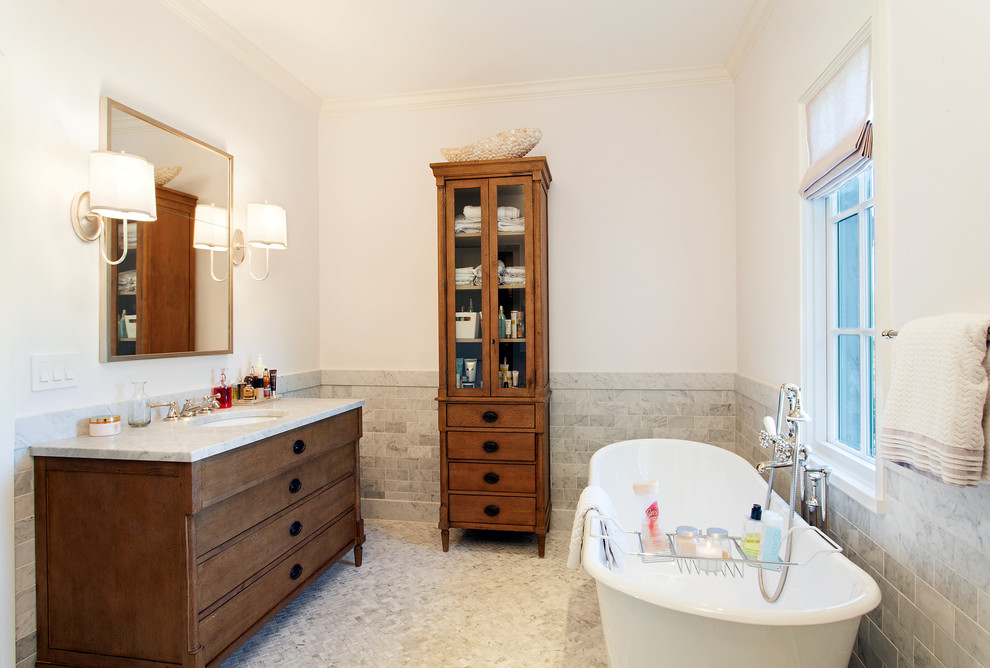 Photo of a medium sized traditional shower room bathroom in Austin with a submerged sink, dark wood cabinets, grey tiles, white walls, mosaic tile flooring, a freestanding bath, stone tiles, quartz worktops, grey floors and flat-panel cabinets.